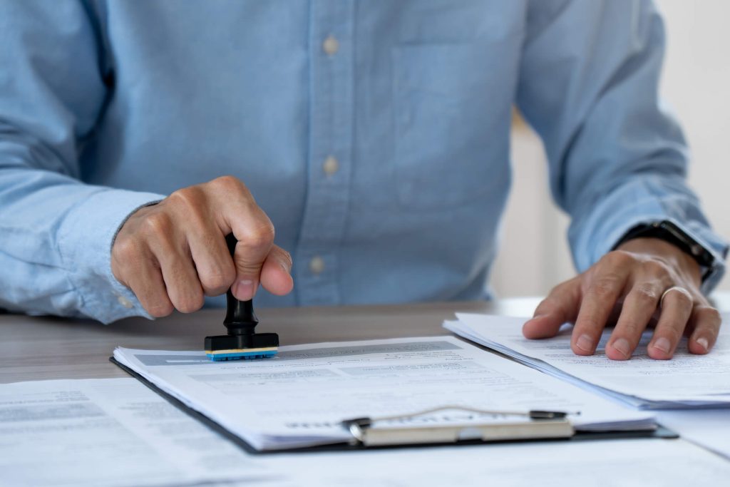 Notary stamps the document in a folder